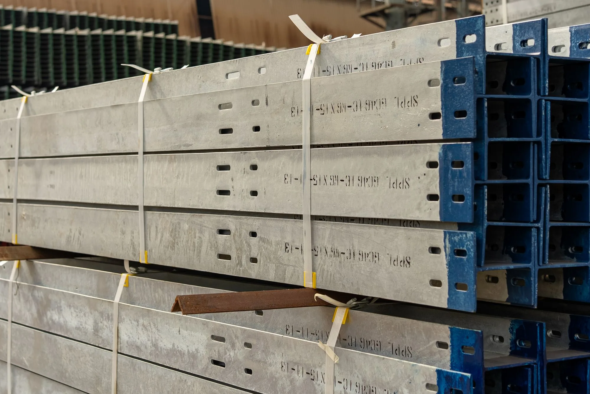 Industrial metal sections secured in bundles with plastic strapping